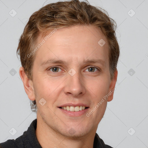 Joyful white adult male with short  brown hair and grey eyes