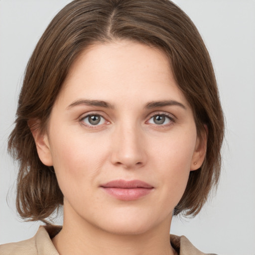 Joyful white young-adult female with medium  brown hair and grey eyes