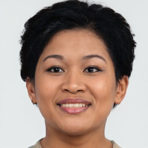Joyful latino young-adult female with short  black hair and brown eyes