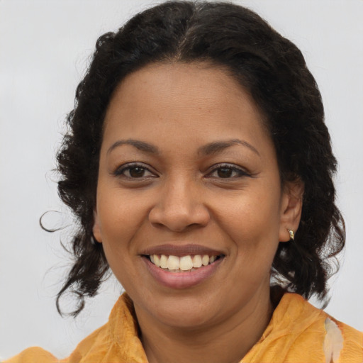 Joyful latino adult female with long  brown hair and brown eyes