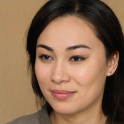 Joyful asian young-adult female with long  brown hair and brown eyes