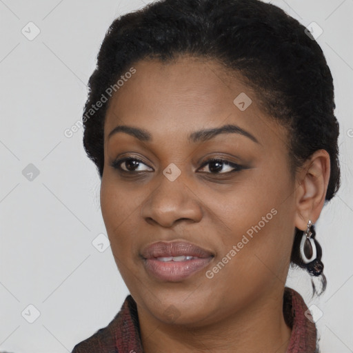 Joyful black young-adult female with long  black hair and brown eyes