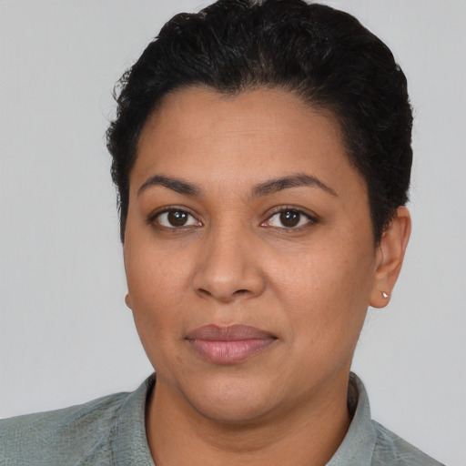 Joyful latino young-adult female with short  black hair and brown eyes