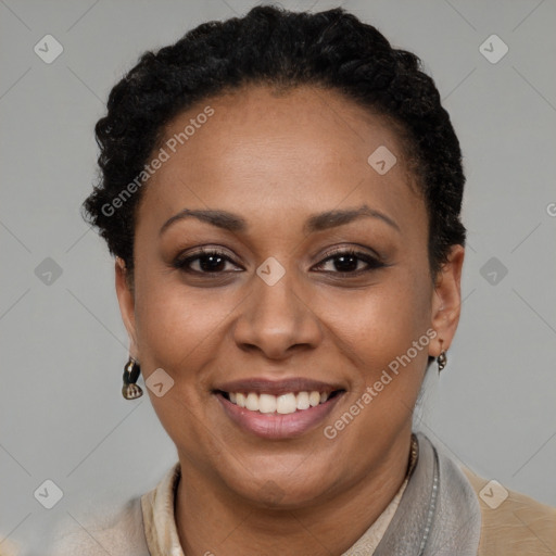 Joyful black adult female with short  brown hair and brown eyes