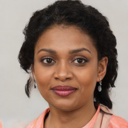 Joyful black young-adult female with medium  brown hair and brown eyes