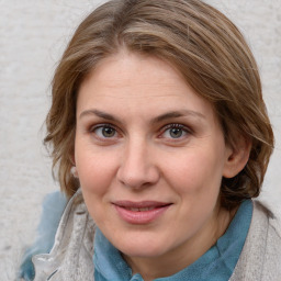 Joyful white adult female with medium  brown hair and blue eyes