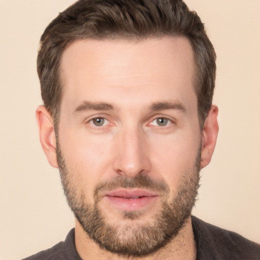 Joyful white adult male with short  brown hair and brown eyes