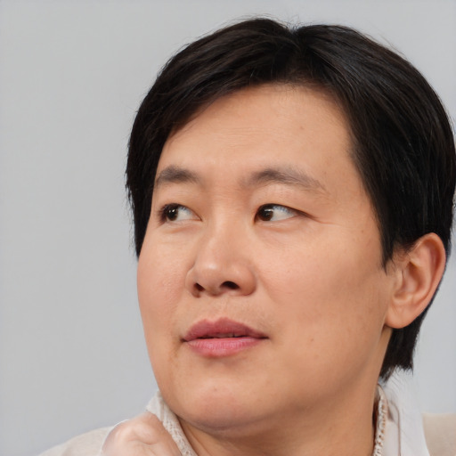 Joyful asian adult male with medium  brown hair and brown eyes
