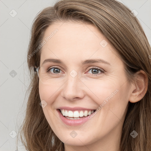 Joyful white young-adult female with long  brown hair and grey eyes