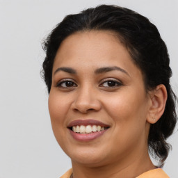 Joyful latino young-adult female with medium  brown hair and brown eyes