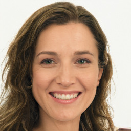 Joyful white young-adult female with long  brown hair and green eyes