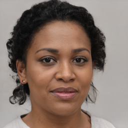 Joyful black adult female with medium  brown hair and brown eyes