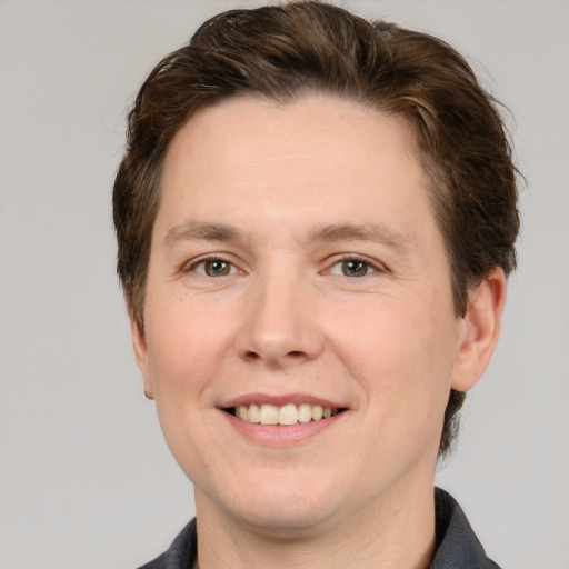 Joyful white adult male with short  brown hair and grey eyes