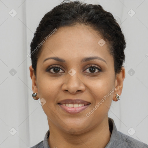 Joyful black young-adult female with short  brown hair and brown eyes
