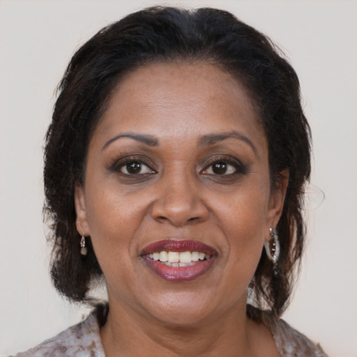 Joyful latino adult female with medium  brown hair and brown eyes