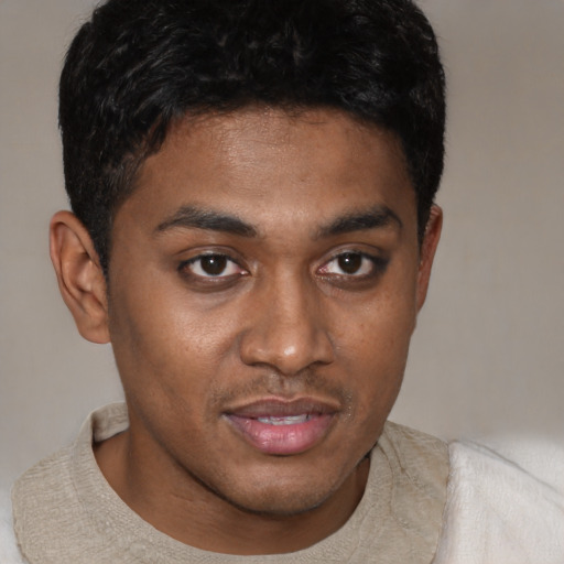 Joyful latino young-adult male with short  brown hair and brown eyes