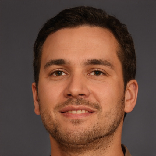 Joyful white young-adult male with short  brown hair and brown eyes