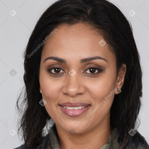 Joyful black young-adult female with long  brown hair and brown eyes