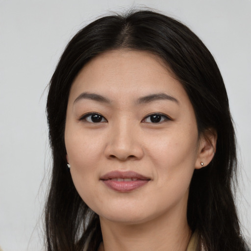 Joyful asian young-adult female with long  brown hair and brown eyes