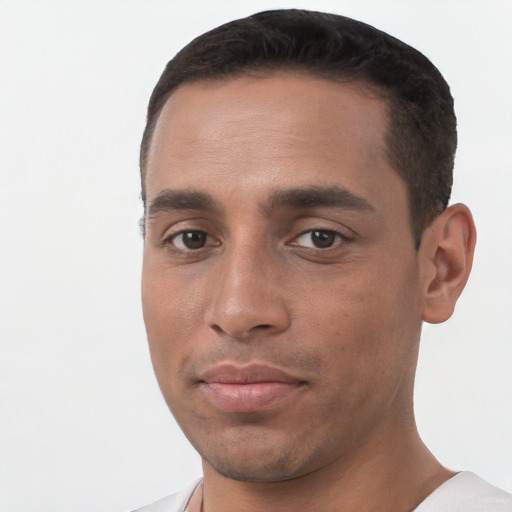 Joyful white young-adult male with short  black hair and brown eyes