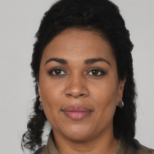 Joyful black adult female with short  black hair and brown eyes