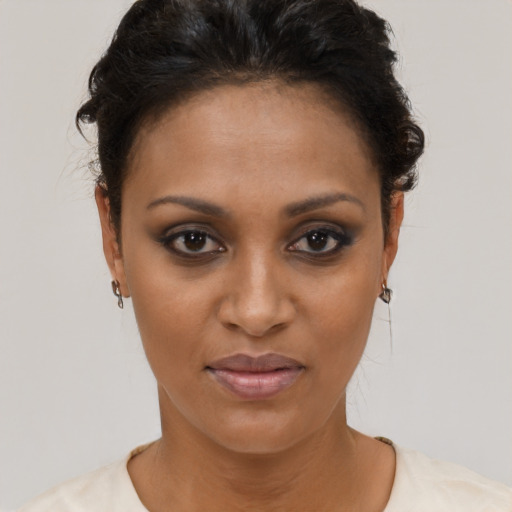 Joyful black young-adult female with short  brown hair and brown eyes
