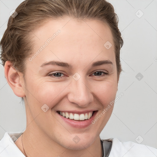 Joyful white young-adult female with short  brown hair and grey eyes