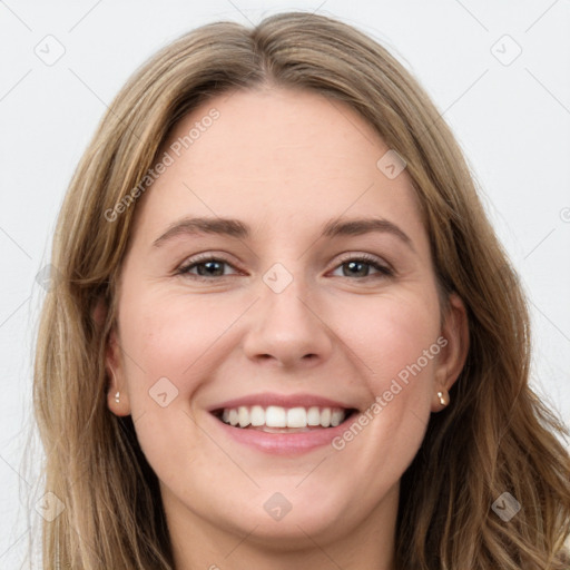 Joyful white young-adult female with long  brown hair and green eyes