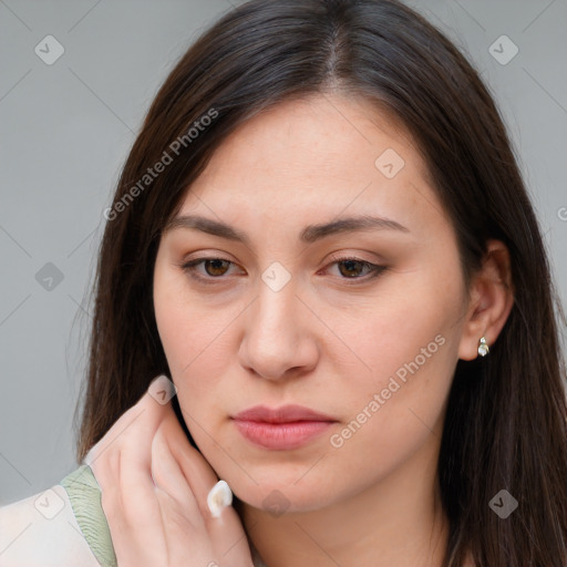 Joyful white young-adult female with long  brown hair and brown eyes