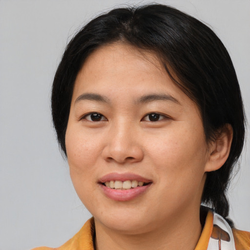 Joyful asian young-adult female with medium  brown hair and brown eyes