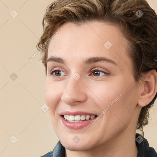 Joyful white young-adult female with medium  brown hair and grey eyes