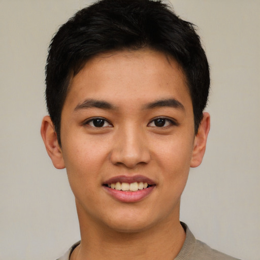 Joyful asian young-adult male with short  black hair and brown eyes