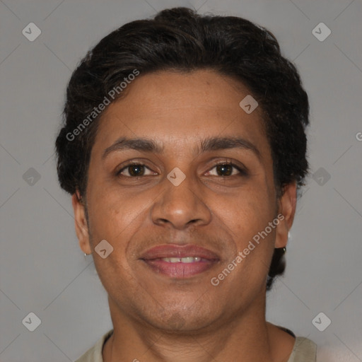 Joyful black adult male with short  brown hair and brown eyes