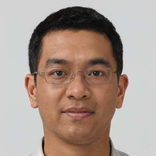 Joyful asian adult male with short  black hair and brown eyes