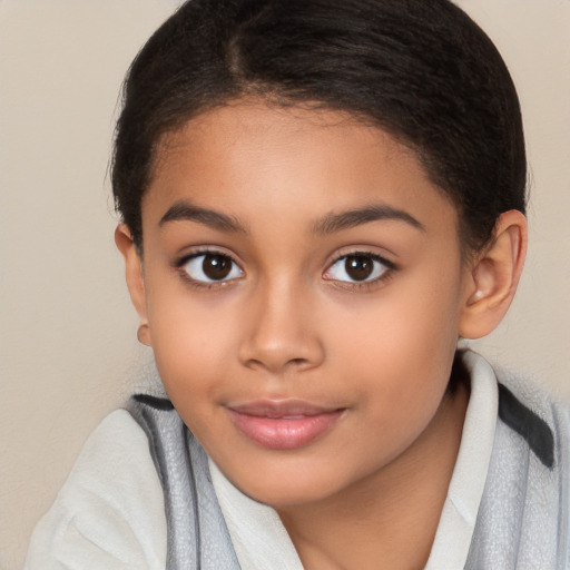 Joyful latino child female with medium  brown hair and brown eyes