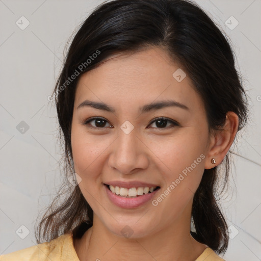 Joyful latino young-adult female with medium  brown hair and brown eyes