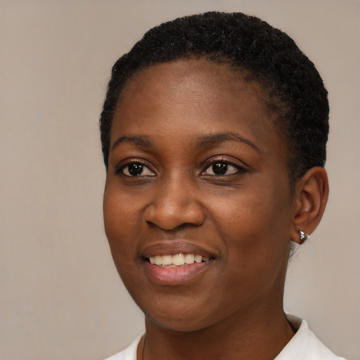 Joyful black young-adult female with short  brown hair and brown eyes
