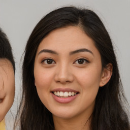 Joyful asian young-adult female with long  brown hair and brown eyes