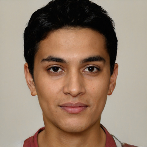 Joyful latino young-adult male with short  black hair and brown eyes