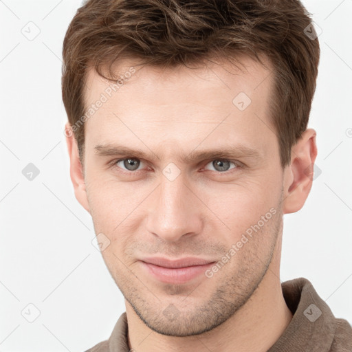 Joyful white young-adult male with short  brown hair and grey eyes