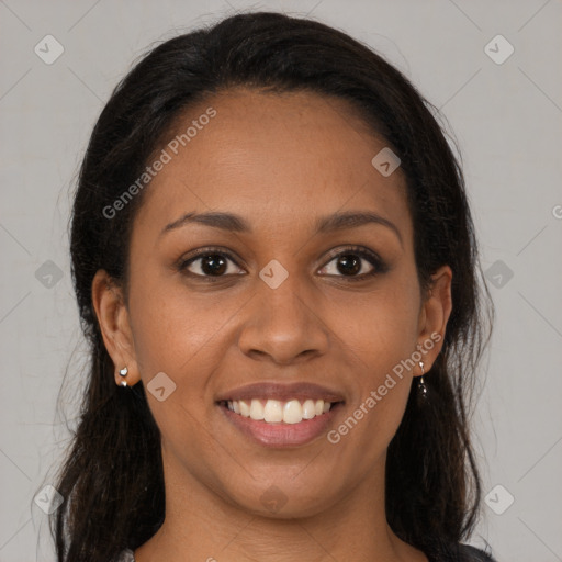 Joyful black young-adult female with long  brown hair and brown eyes