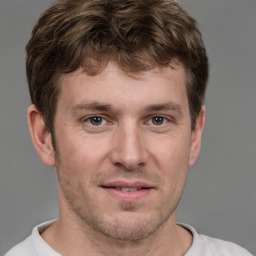 Joyful white adult male with short  brown hair and brown eyes