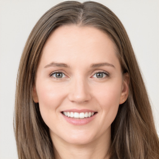 Joyful white young-adult female with long  brown hair and grey eyes