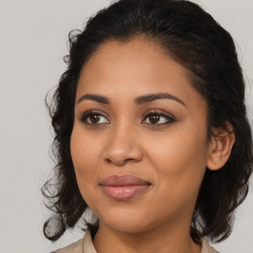 Joyful latino young-adult female with medium  brown hair and brown eyes