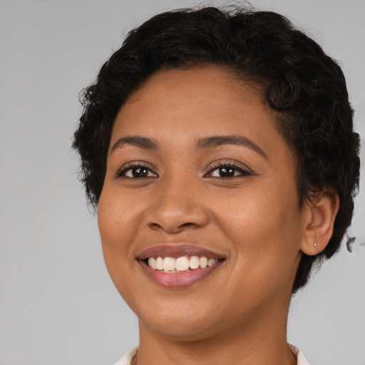 Joyful latino young-adult female with short  brown hair and brown eyes