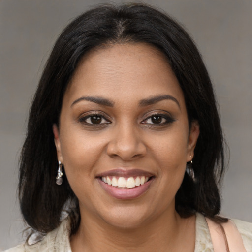 Joyful black young-adult female with medium  brown hair and brown eyes