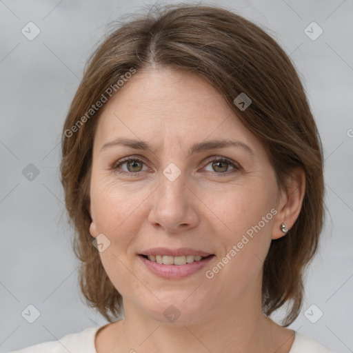 Joyful white adult female with medium  brown hair and grey eyes