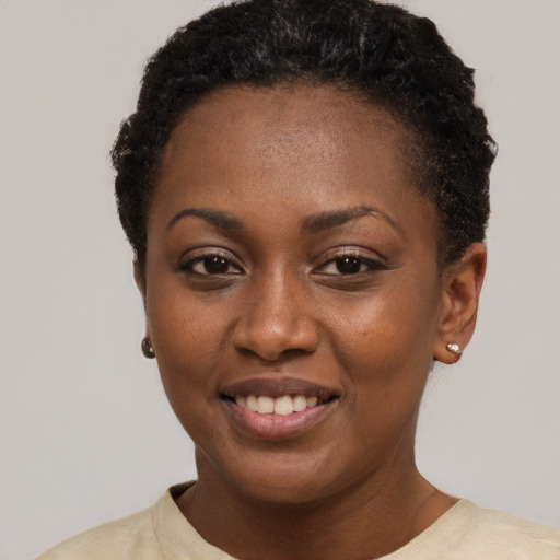 Joyful black young-adult female with short  brown hair and brown eyes