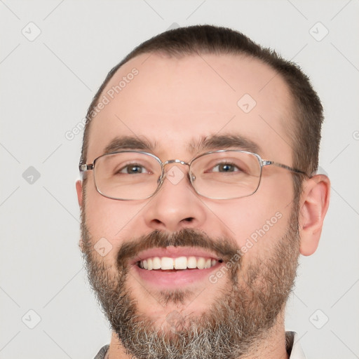 Joyful white adult male with short  brown hair and brown eyes