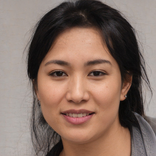 Joyful asian young-adult female with medium  brown hair and brown eyes